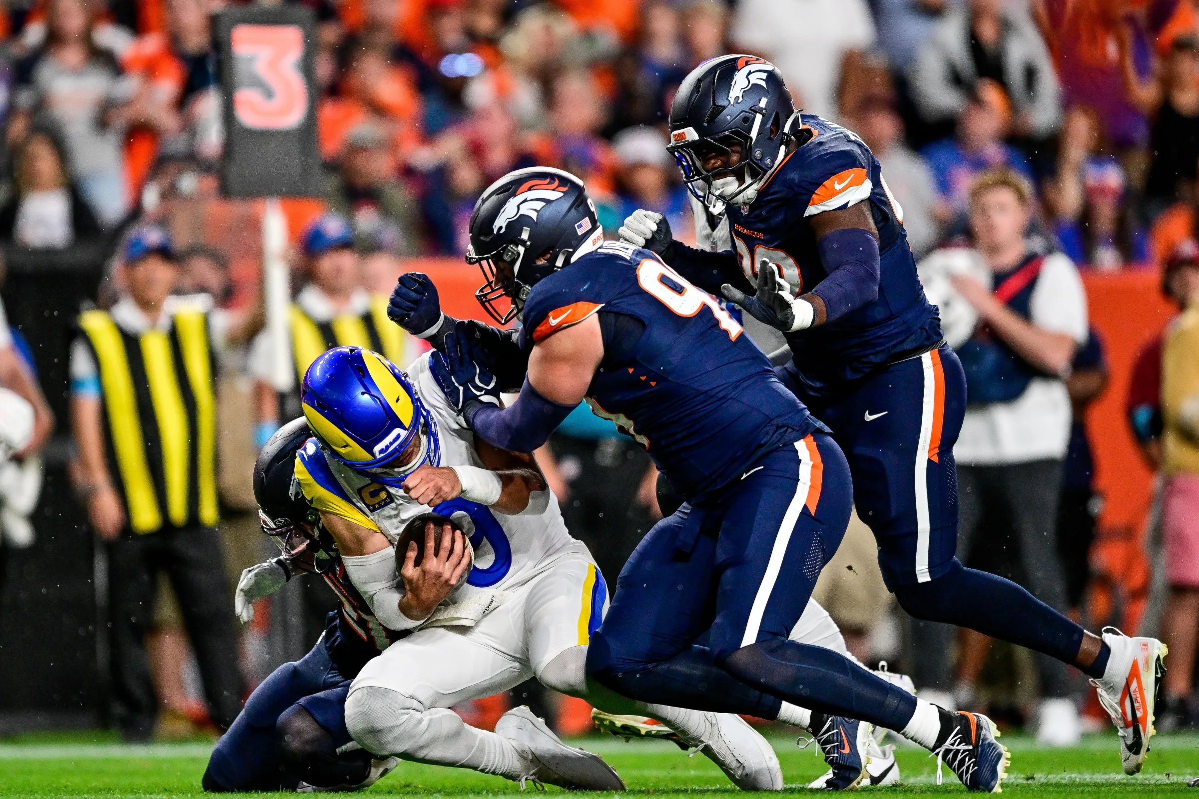 DENVER, CO - SEPTEMBER 27: Los Angeles Rams quarterback Matthew Stafford (9) is tackled by Denver Broncos defensive end Zach Allen (99) after a run in the first quarter during a game between the Los Angeles Rams and the Denver Broncos at Empower Field at Mile High on September 27, 2026 in Denver, Colorado. (Photo by Dustin Bradford/Icon Sportswire via Getty Images)