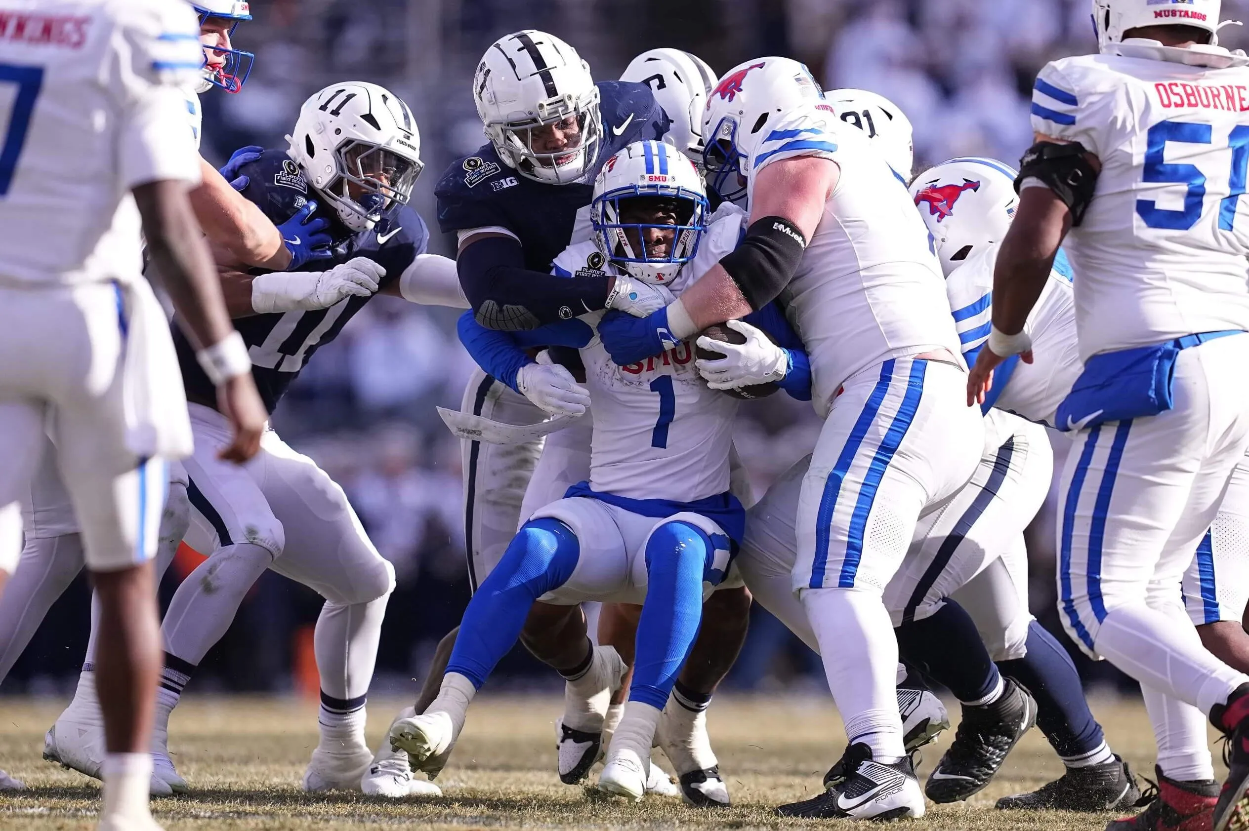 Kobe King of the Penn State Nittany Lions tackles Brashard Smith of the Southern Methodist Mustangs in the Playoff First Round Game on December 21, 2024 in State College, Pennsylvania
