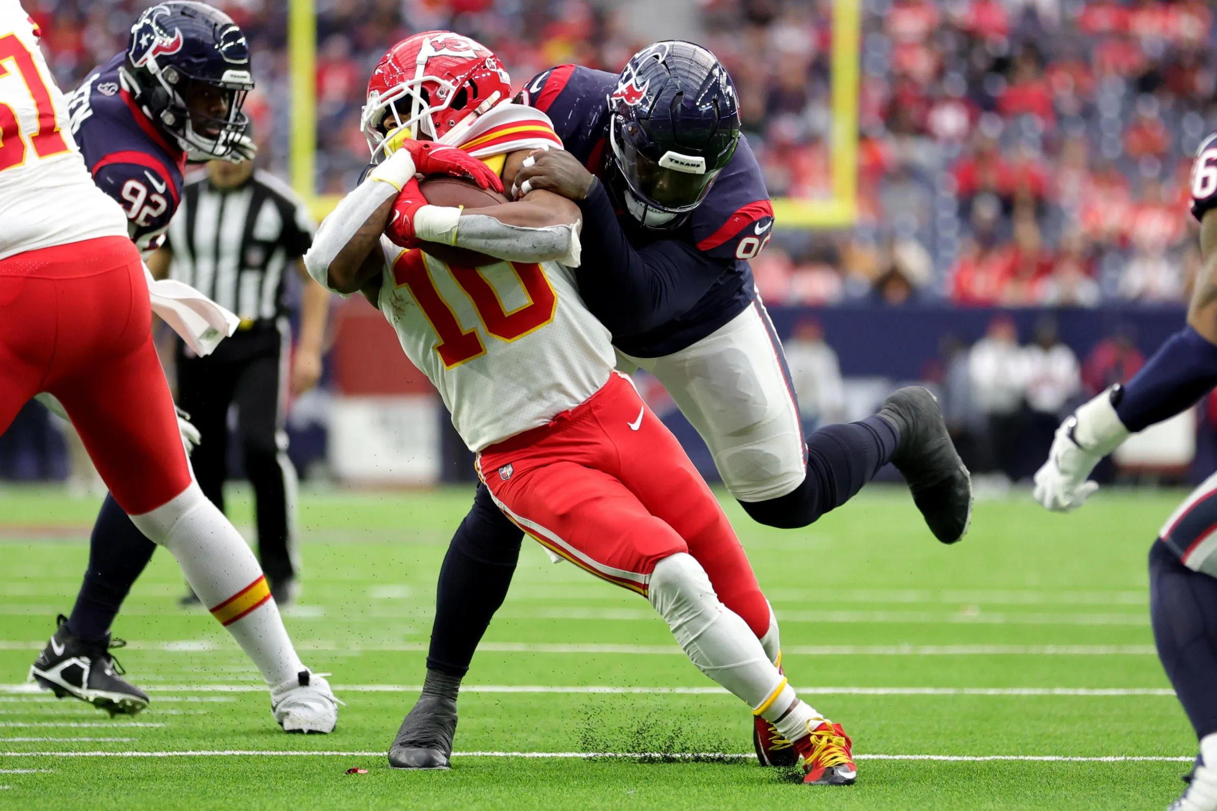 HOUSTON, TEXAS - DECEMBER 18: Isiah Pacheco #10 of the Kansas City Chiefs is covered by Maliek Collins #96 of the Houston Texans in the third quarter at NRG Stadium on December 18, 2022 in Houston, Texas. (Photo by Carmen Mandato/Getty Images)
