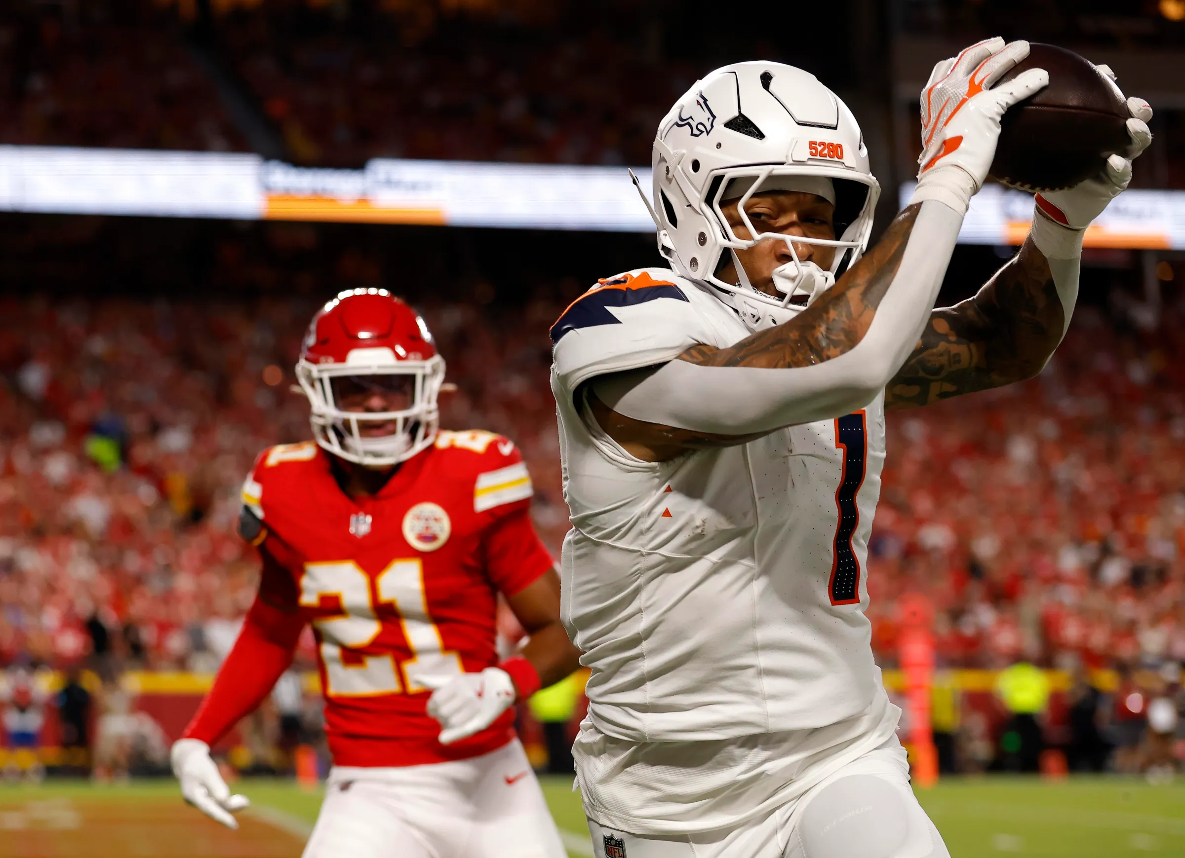 KANSAS CITY, MISSOURI - SEPTEMBER 14: Evan Engram #1 of the Denver Broncos scores a 19 yard touchdown against Jaden Hicks #21 of the Kansas City Chiefs in the first quarter of the game at Arrowhead Stadium on September 14, 2026 in Kansas City, Missouri. (Photo by David Eulitt/Getty Images)