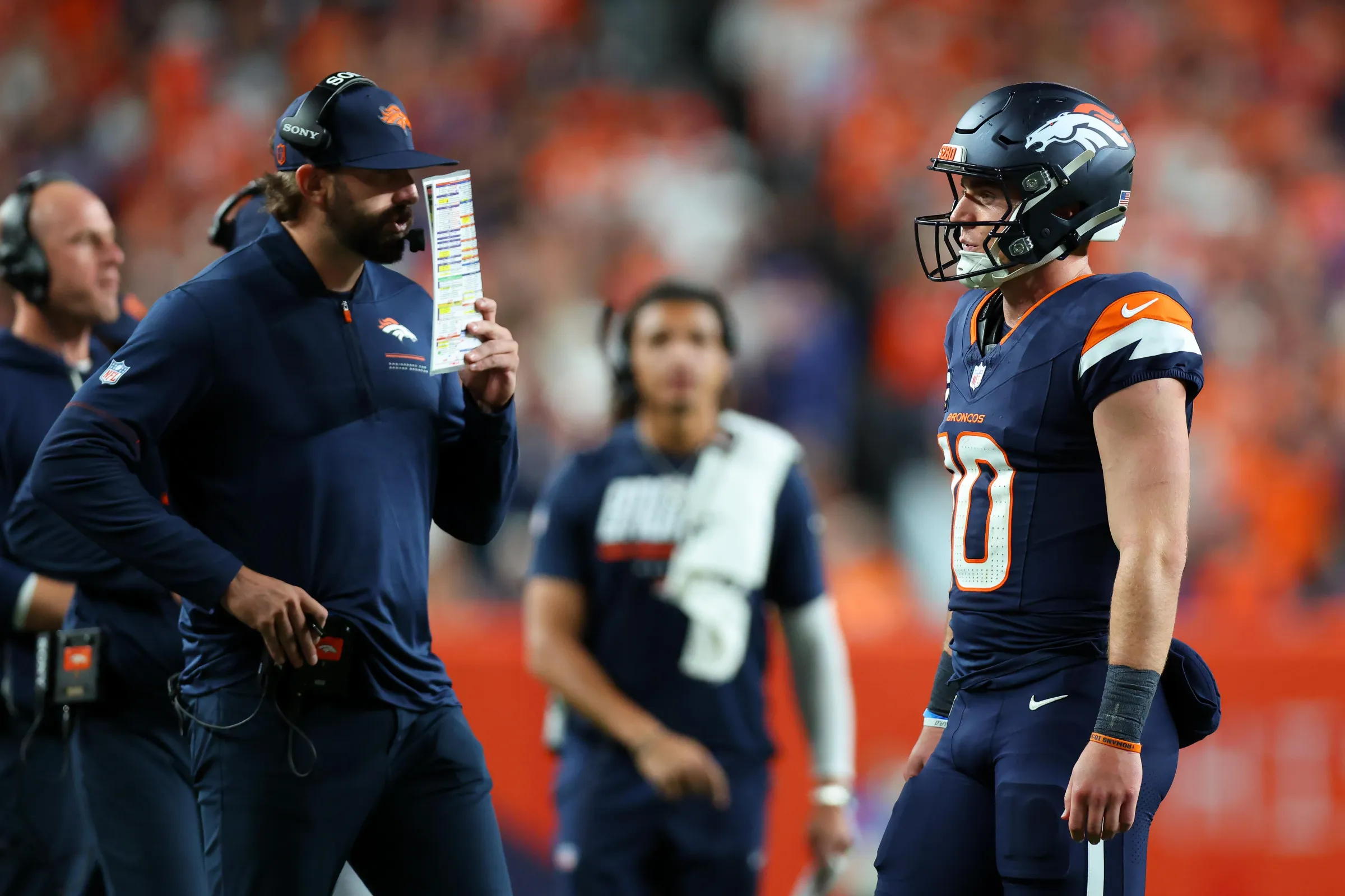 DENVER, CO - SEPTEMBER 27: Offensive coordinator Davis Webb of the Denver Broncos calls a play as Bo Nix #10 of the Denver Broncos looks on during the fourth quarter against the Los Angeles Rams at Empower Field at Mile High on September 27, 2026 in Denver, Colorado. (Photo by Justin Edmonds/Getty Images)