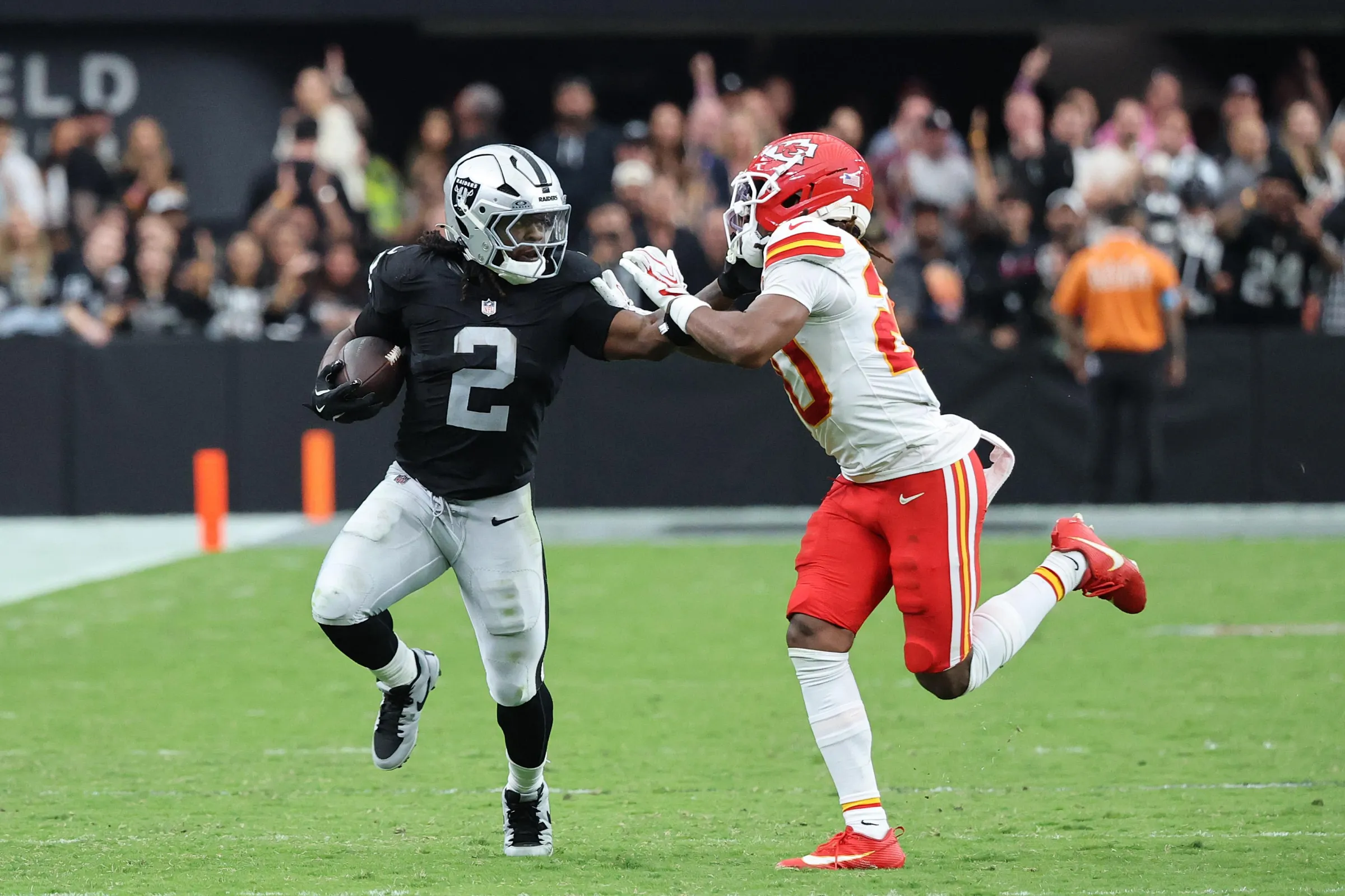 LAS VEGAS, NEVADA - OCTOBER 04: Ashton Jeanty #2 of the Las Vegas Raiders runs with the ball while touching the facemask of Nohl Williams #20 of the Kansas City Chiefs during the fourth quarter at Allegiant Stadium on October 04, 2026 in Las Vegas, Nevada. (Photo by Ethan Miller/Getty Images)