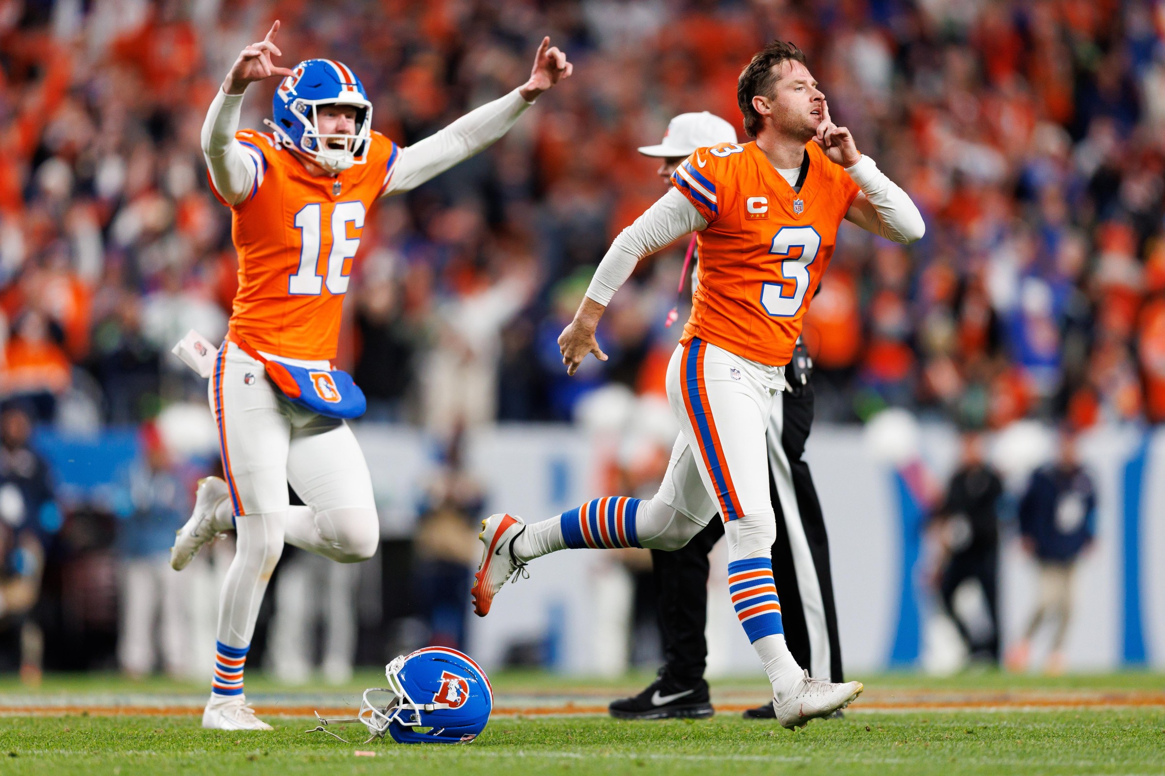 DENVER, COLORADO - OCTOBER 15: Wil Lutz #3 and Jeremy Crawshaw #16 of the Denver Broncos react after kicking the game-winning field goal during overtime of an NFL football game against the Seattle Seahawks at Empower Field at Mile High on October 15, 2026 in Denver, Colorado. (Photo by Brooke Sutton/Getty Images)