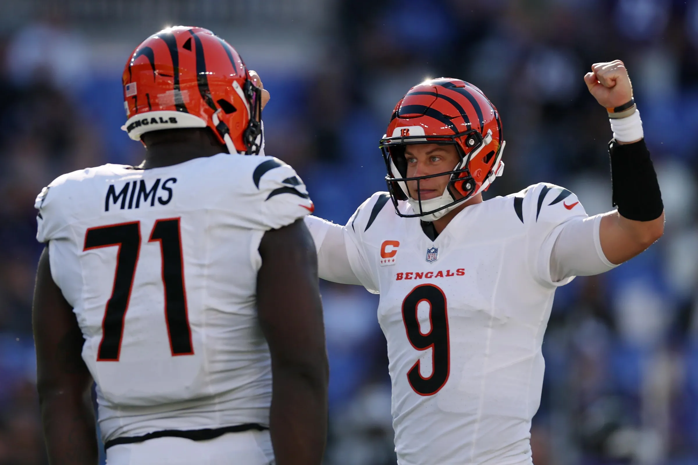 BALTIMORE, MARYLAND - OCTOBER 25: Amarius Mims #71 and Joe Burrow #9 of the Cincinnati Bengals celebrate a touchdown against the Baltimore Ravens in the fourth quarter at M&T Bank Stadium on October 25, 2026 in Baltimore, Maryland. (Photo by Patrick Smith/Getty Images)